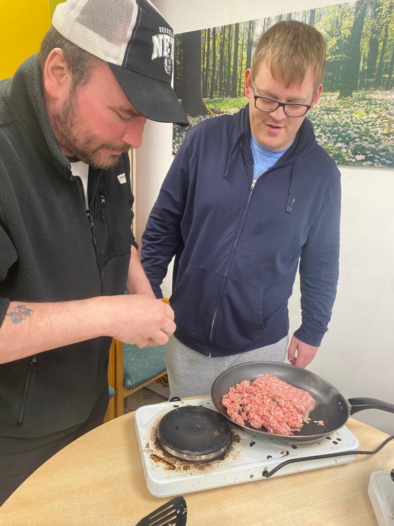 Two individuals cooking together.